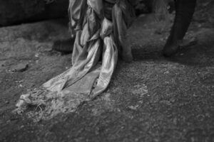 A black and white photo of a person standing on the ground