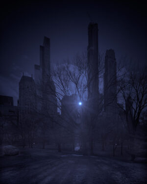 A dark city with trees and buildings in the background.
