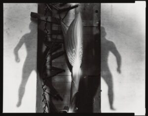 A black and white photo of two men standing next to each other.