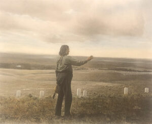 A man standing on top of a hill holding something.