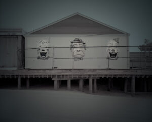 A building with faces painted on it's side.