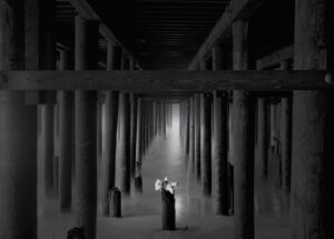 A black and white photo of pillars in the middle of an area.