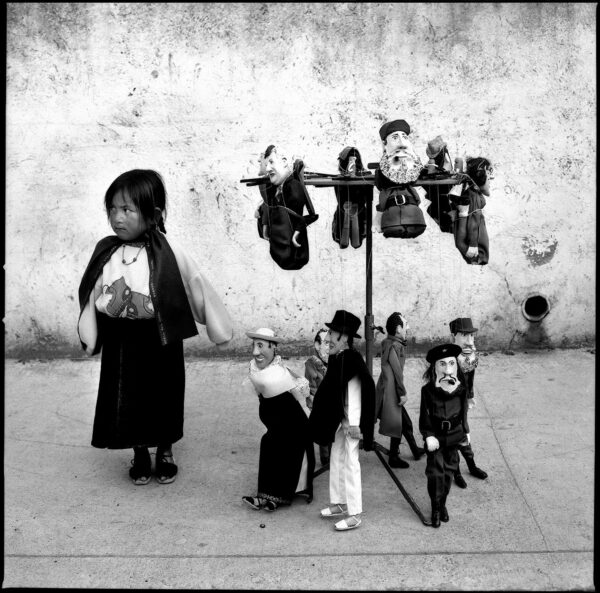 A group of children standing around a woman.