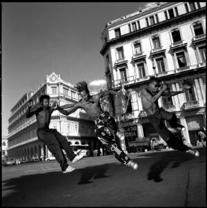 A group of skateboarders jumping in the air.