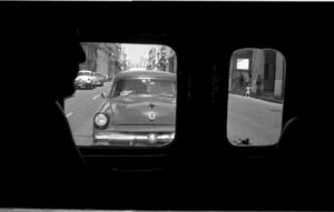 A car is seen through the window of an old car.