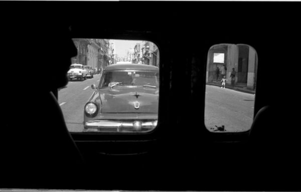 A car is seen through the window of an old car.