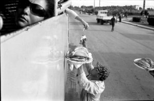 A person reaching for food on the side of a truck.