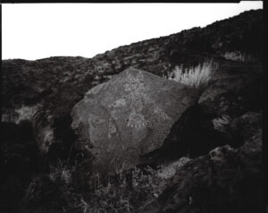A rock sitting on top of a hill.