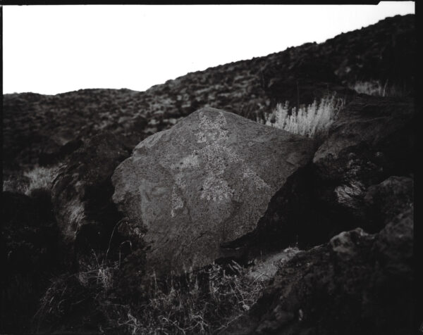 A rock sitting on top of a hill.