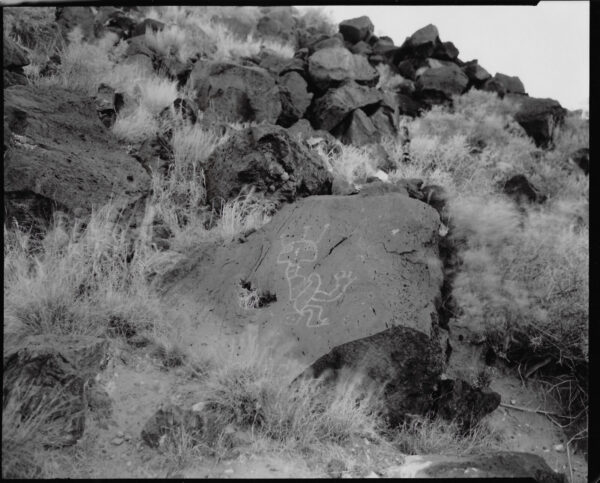 A black and white photo of rocks on the side of a hill.