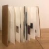 A book with several pages folded in to form a folding screen.