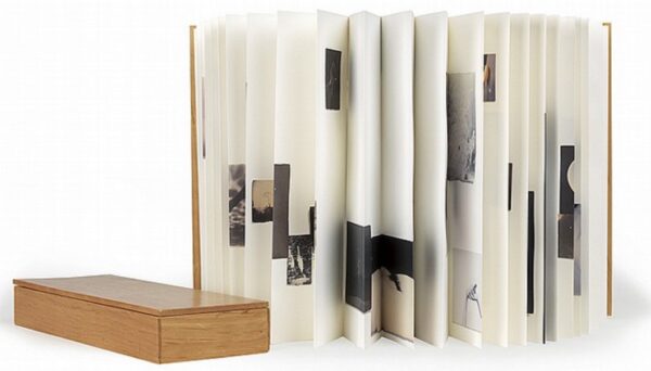 A book with many pictures on it and some papers