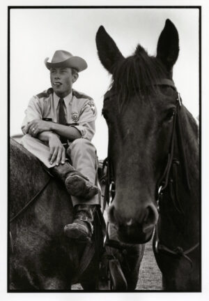 A man sitting on top of a horse.