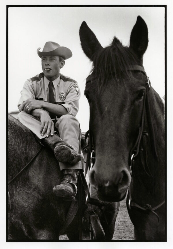 A man sitting on top of a horse.