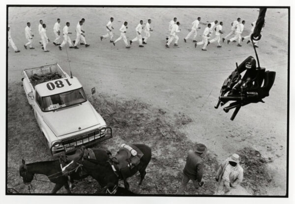 A group of men walking down the street.