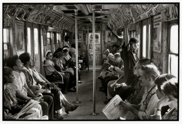 A group of people sitting on top of a train.