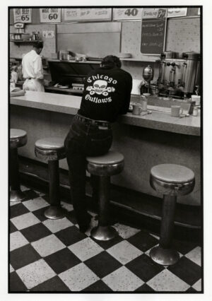A man sitting at the counter of a diner.