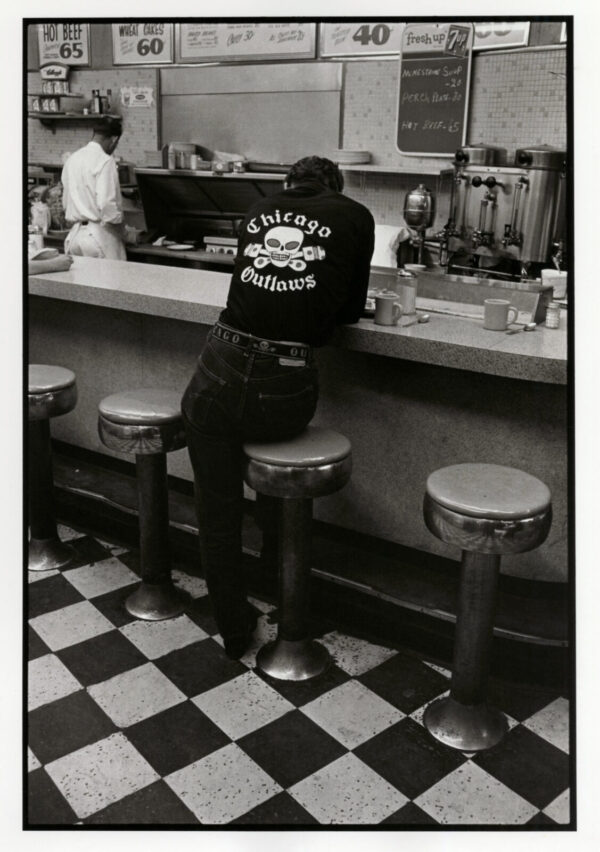 A man sitting at the counter of a diner.