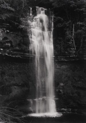 A black and white photo of a waterfall