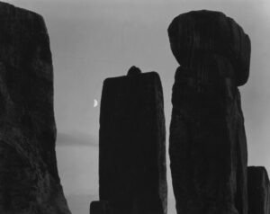 A black and white photo of three large stones.