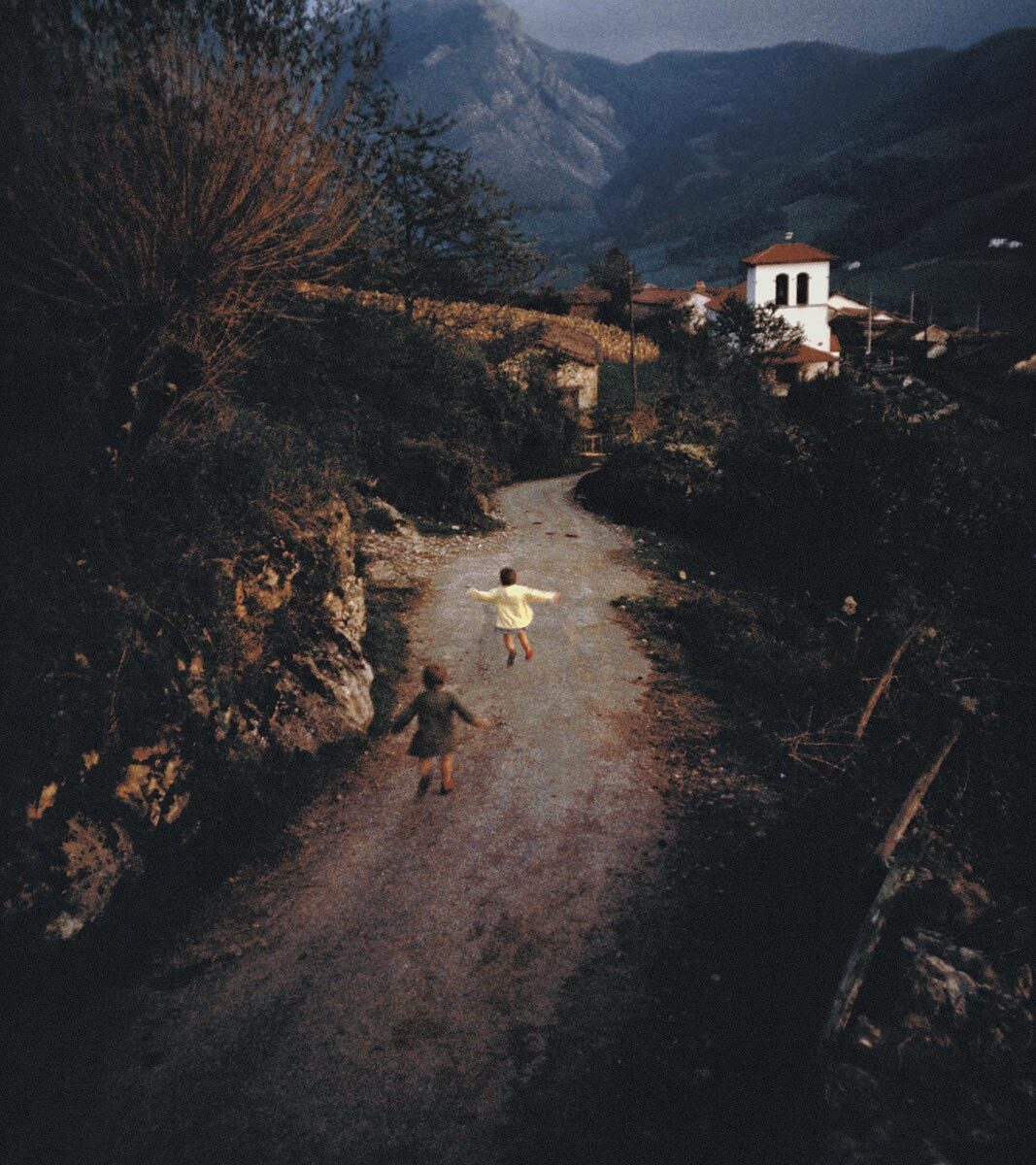 Children playing on a rural dirt road.