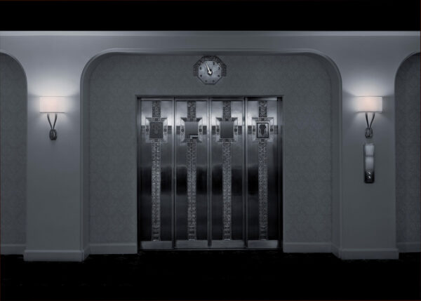 A clock is on the wall in front of an elevator.