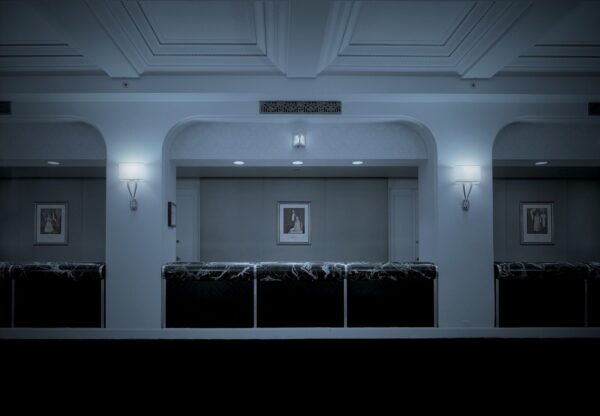 A room with a picture on the wall and lights