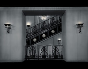 A black and white photo of an open door.
