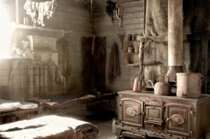 A room with an old fashioned stove and many items.