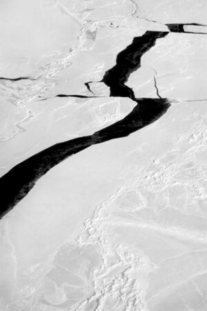 A black and white photo of snow covered ground.
