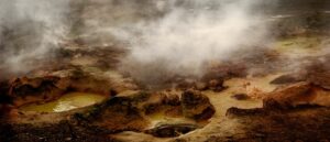 A large rock formation with steam coming out of it.