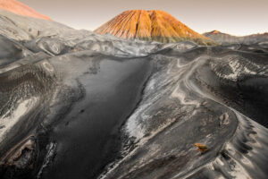 A mountain with a large crater in the background.