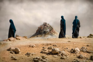 A group of people walking on the desert