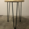 A table with metal legs and a gold top.