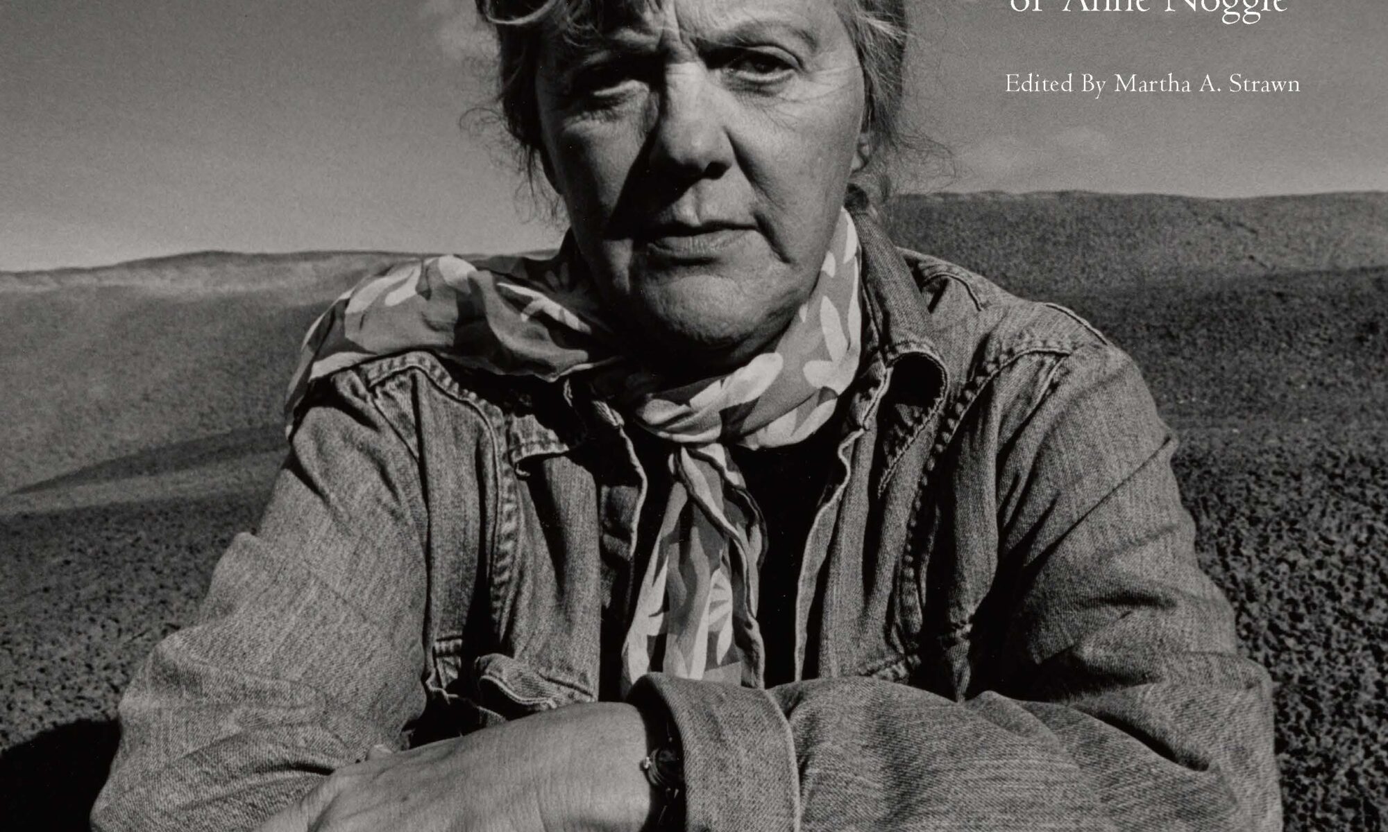 Woman in denim jacket and scarf.