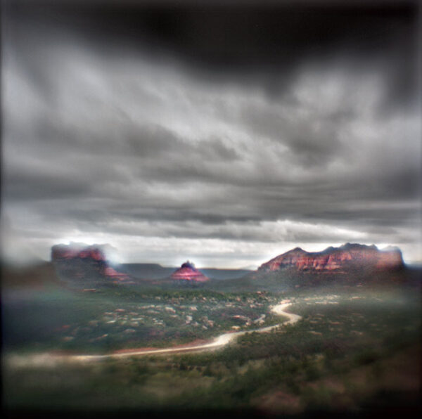 A view of the mountains from above with dark clouds.