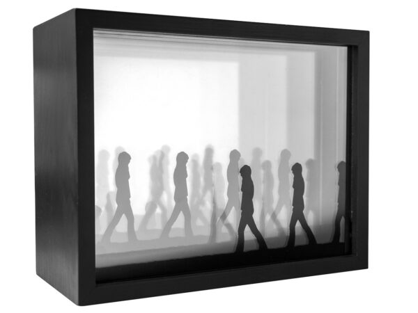A black and white photo of a group of people walking.
