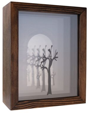 A shadow box with trees and a moon in the background.