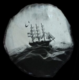 A ship is seen through the glass of a telescope.