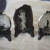 Three small plates with a picture of a hand and a ship.