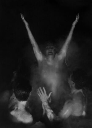 A group of people standing in the dark.