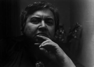 A man with his hand on his chin.