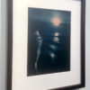 A framed photograph of a woman in the water.