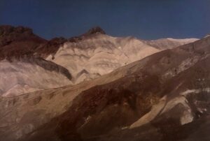 A mountain range with snow on it's side.