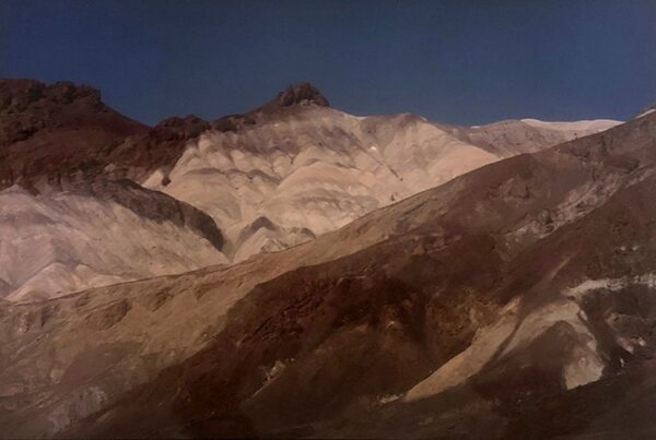 A mountain range with snow on it's side.