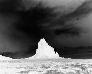 A black and white photo of a mountain in the middle of nowhere.