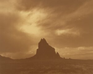 A mountain with a sky background in sepia