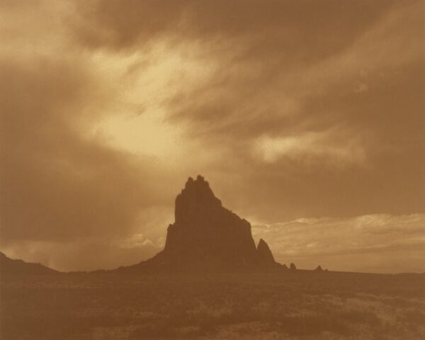 A mountain with a sky background in sepia