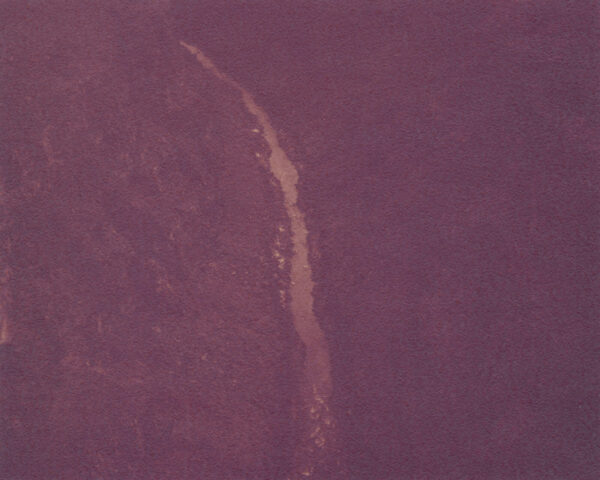 A purple background with a long line of water.