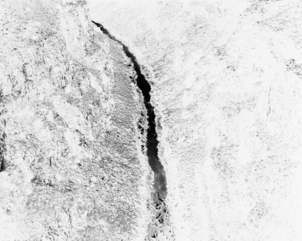 A black and white image of a crack in the ice.